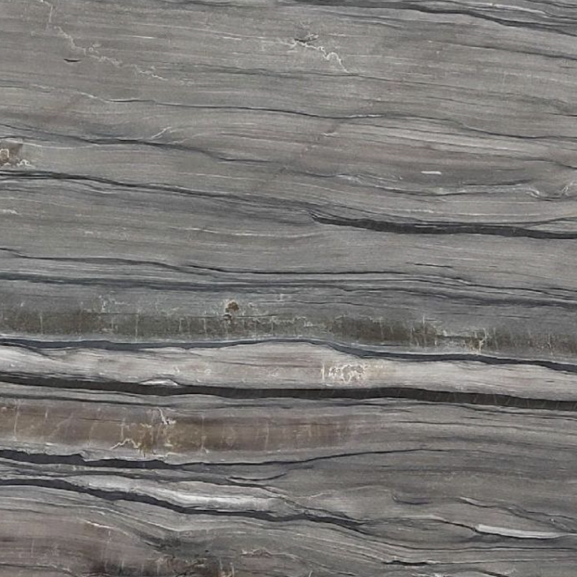 Close-up of gray stone with visible layers and texture